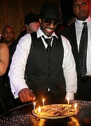 DJ Clue cutting the cake at his b-day