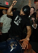 Nelly cutting the cake at the Apple Bottoms 5th anniversary party
