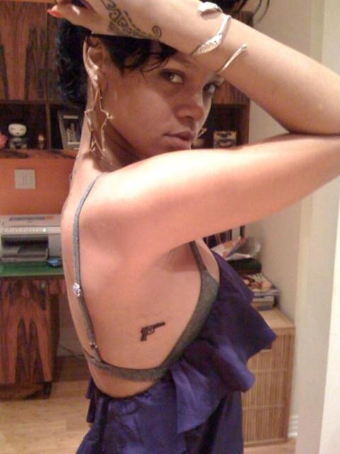 tattoos with quotes. Rihanna#39;s new gun tattoos.