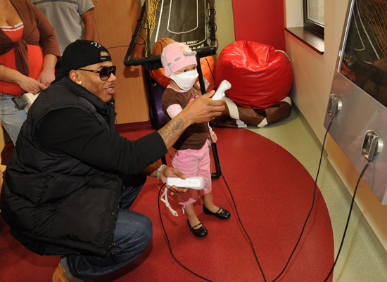 Nelly visits sick children and delivers Christmas gifts at the Aflac Children's Cancer Center of Atlanta