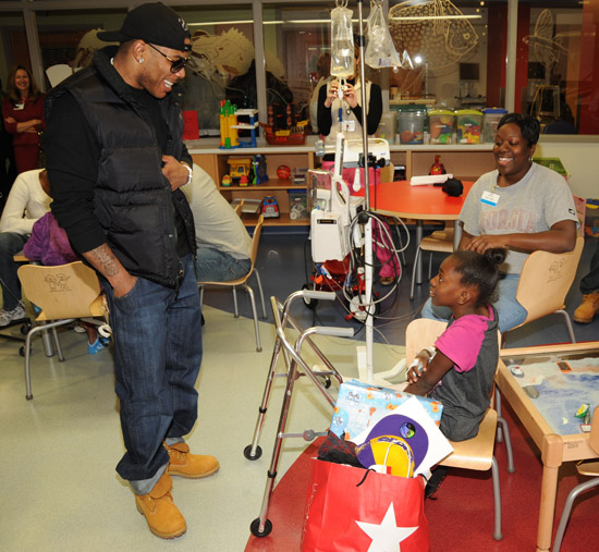 Nelly visits sick children and delivers Christmas gifts at the Aflac Children's Cancer Center of Atlanta