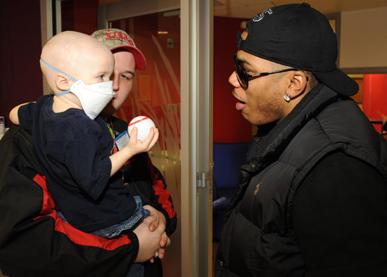 Nelly visits sick children and delivers Christmas gifts at the Aflac Children's Cancer Center of Atlanta