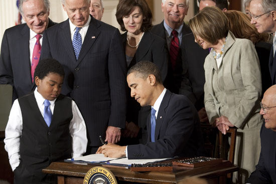 Obama+signing+the+health+care+bill