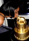 Kelly Rowland kisses her golden cake at her 33rd "Liquid Gold Fondue" Birthday Party