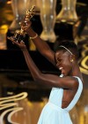 Lupita Nyong'o accepts her Best Supporting Actress award at the 2014 Oscars