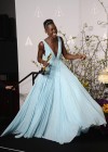 Lupita Nyong'o shows off her award in the press room backstage at the 2014 Oscars