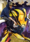 Chris Brown sitting in his graffiti filled house
