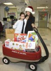 Adrienne Bailon delivering Christmas gifts to sick children at the Beth Israel Medical Center in New York City