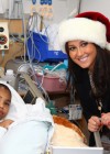 Adrienne Bailon delivering Christmas gifts to sick children at the Beth Israel Medical Center in New York City