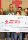 Chris hands over a $25,000 check to the American Red Cross