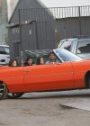 Chris Brown with Karrauche and friends riding in a bright orange chevy impala drop-top hoopty
