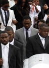 Kile Glover’s father Ryan Glover (in the grey suit) walks behind his casket after his funeral in Atlanta