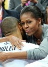 Michelle Obama hugs U.S. men’s Olympic basketball team after their first win
