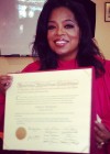 Oprah Winfrey holding her honory “Doctor of Law” degree from Harvard University