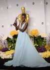 Lupita Nyong’o shows off her award in the press room backstage at the 2014 Oscars