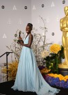 Lupita Nyong’o shows off her award in the press room backstage at the 2014 Oscars